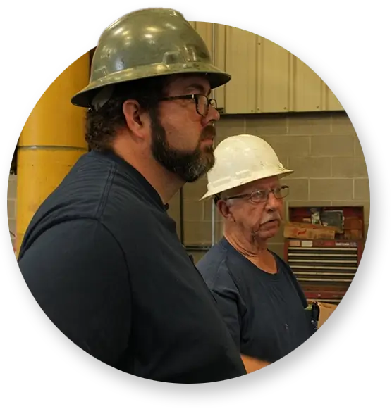 Two Devall Diesel employees in white and green hard hats