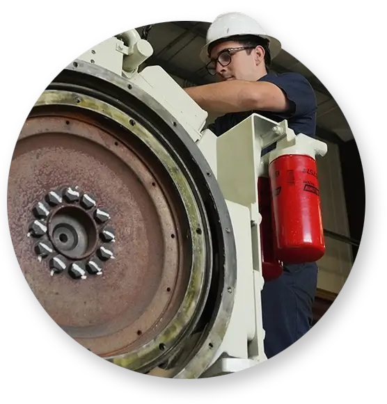 A Devall Diesel technician working on a large white diesel generator
