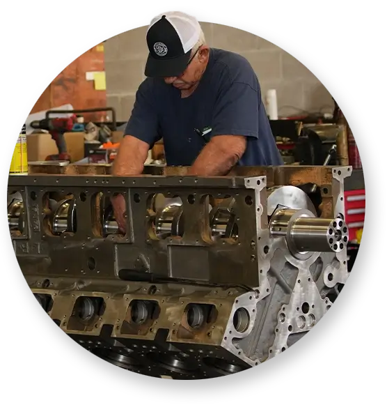 A Devall Diesel technician adjusting a cylinder in a diesel engine