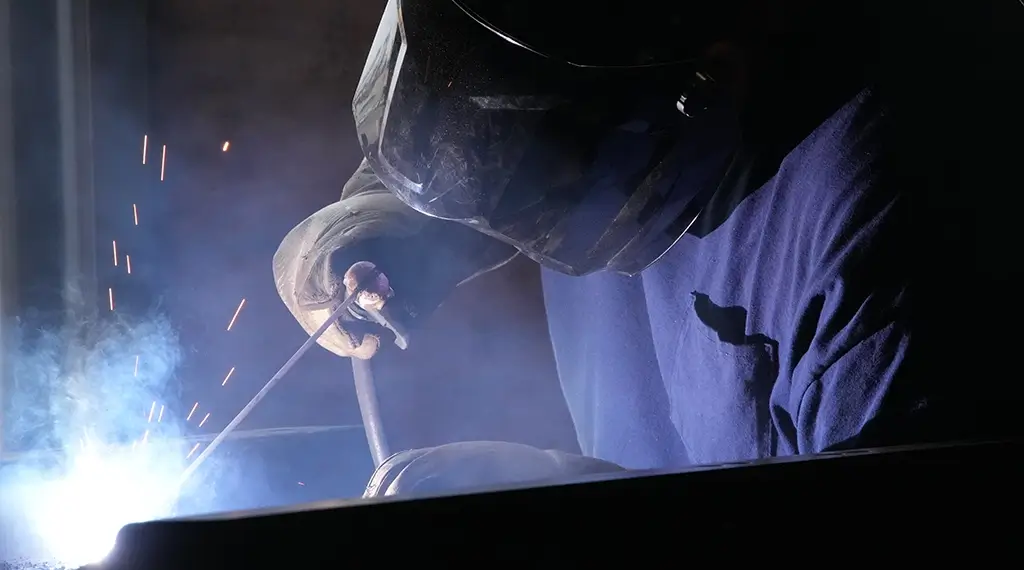 A Devall Diesel worker welding pipes