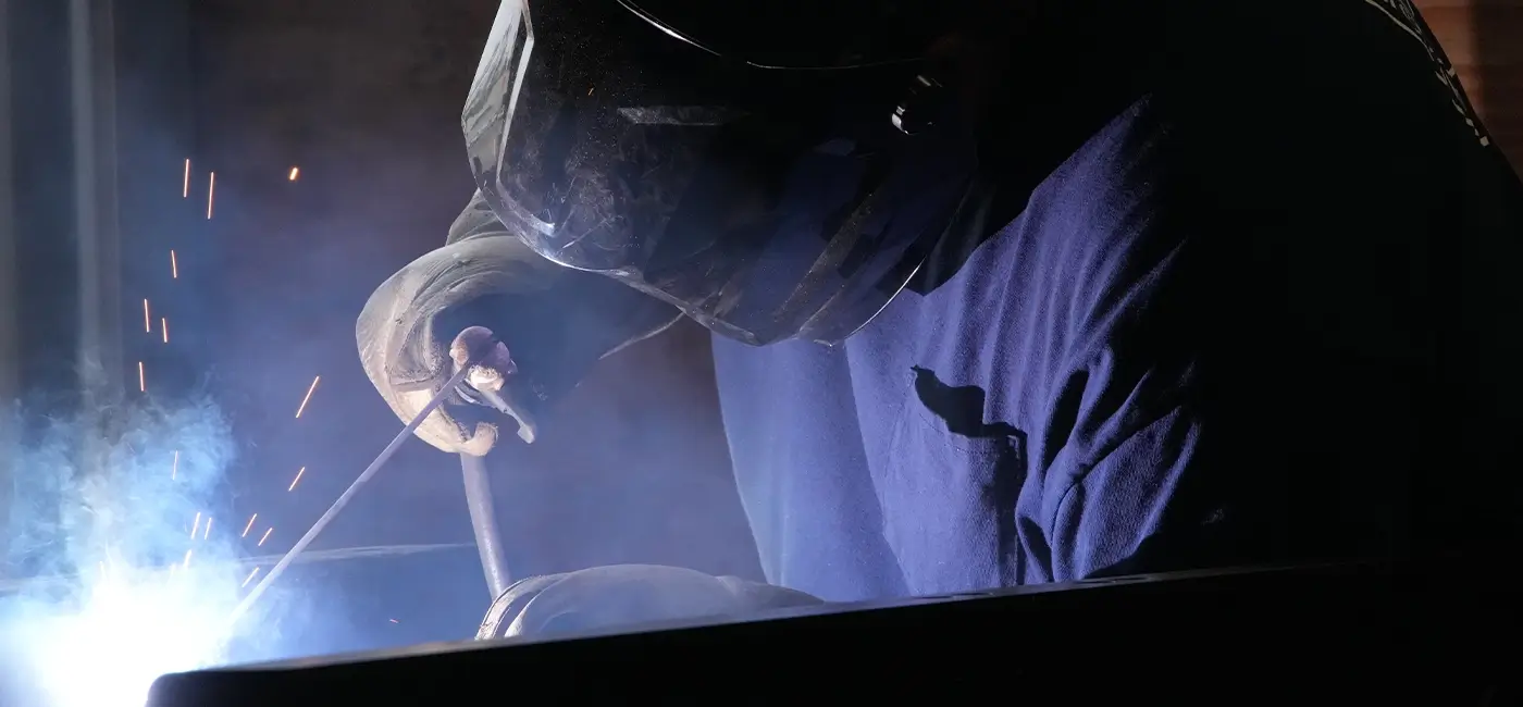 A Devall Diesel worker welding pipes