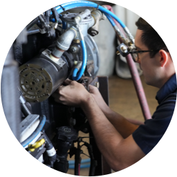 A Devall Diesel technician tightening screws on a diesel