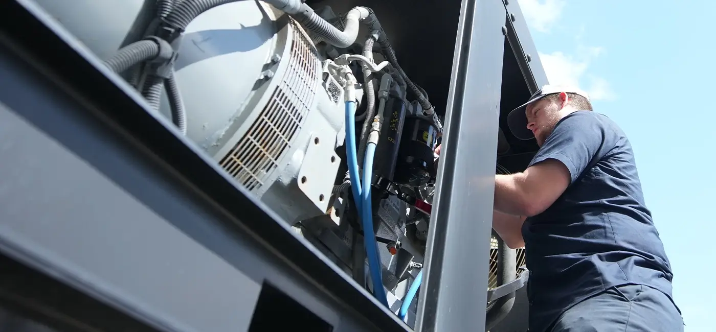 A Devall Diesel technician installing a diesel engine