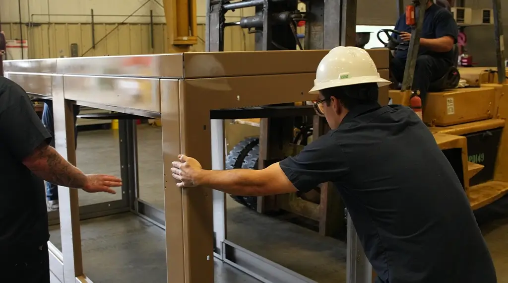 Two Devall Diesel Technicians assembling a generator frame