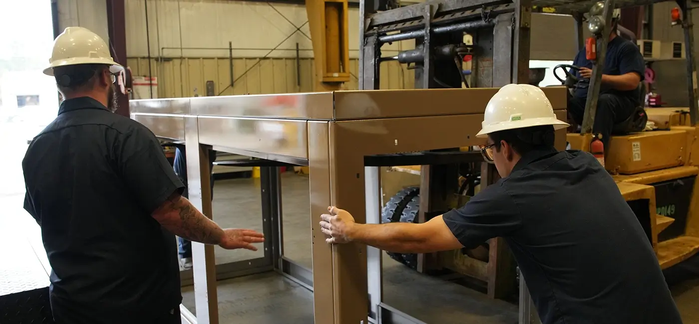 Two Devall Diesel Technicians assembling a generator frame