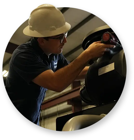 A Devall Diesel technician tightening a valve on a diesel engine