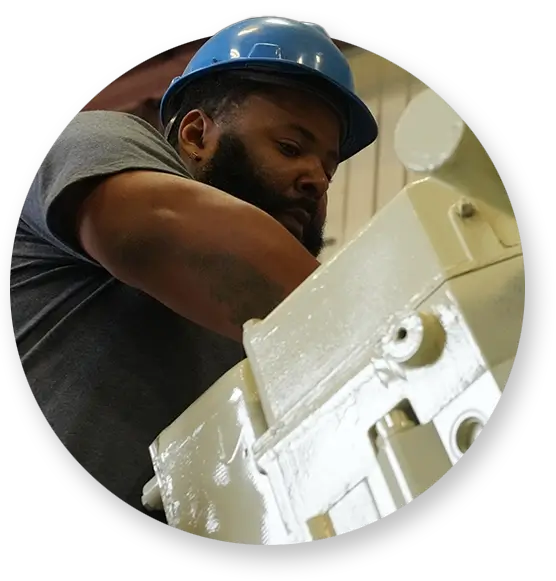 A Devall Diesel technician reaching into a generator