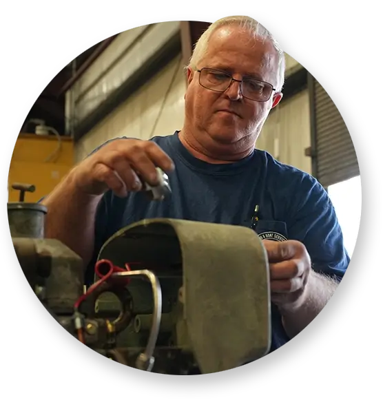 A Devall Diesel technician examining a bolt