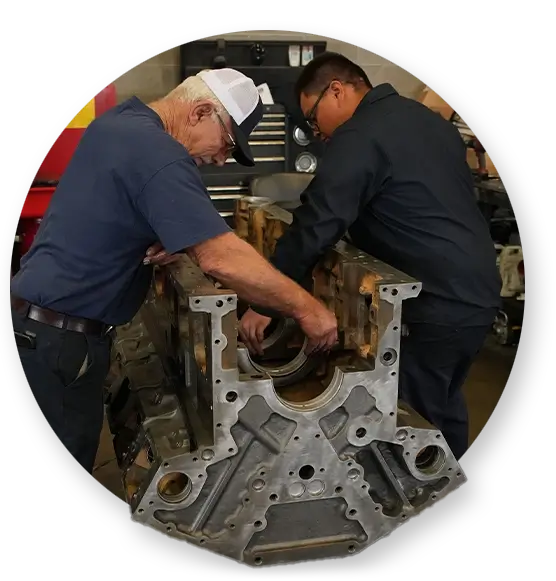 Two Devall Diesel technicians assembling a diesel engine