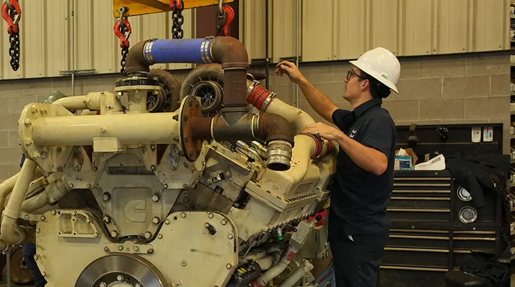 Two Devall Diesel workers examining a large diesel engine