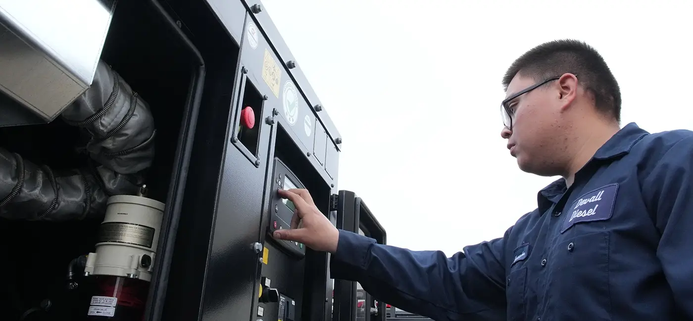 A Devall Diesel Technician turning on a diesel generator