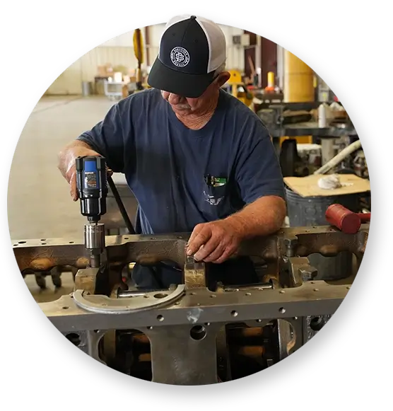 An Devall Diesel Technician screwing in bolts