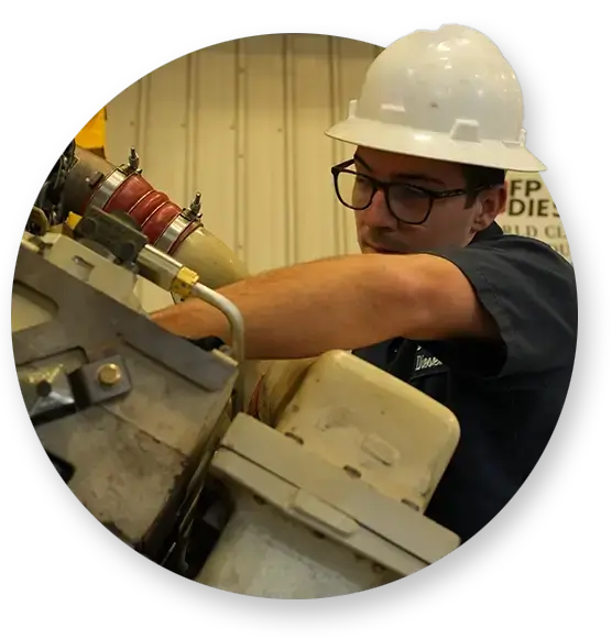 A Devall Diesel technician working on a diesel engine