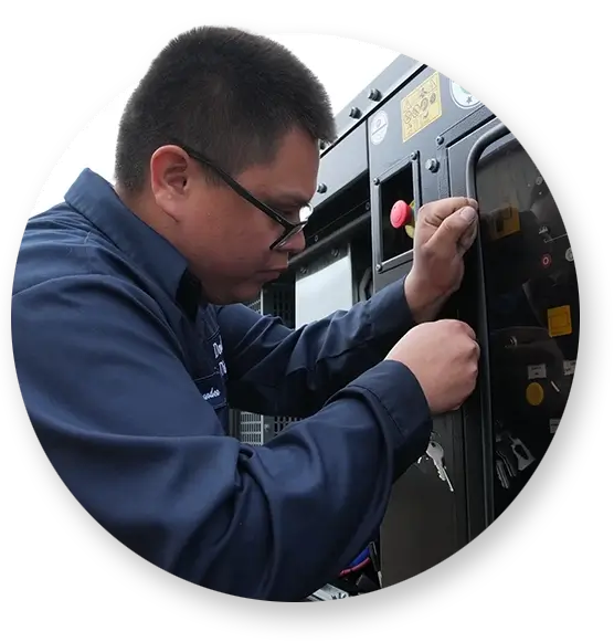 A Devall Diesel technician adjusting a panel on a black diesel generator