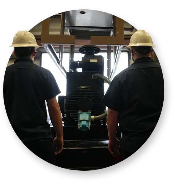 Two Devall Diesel workers looking at a diesel generator